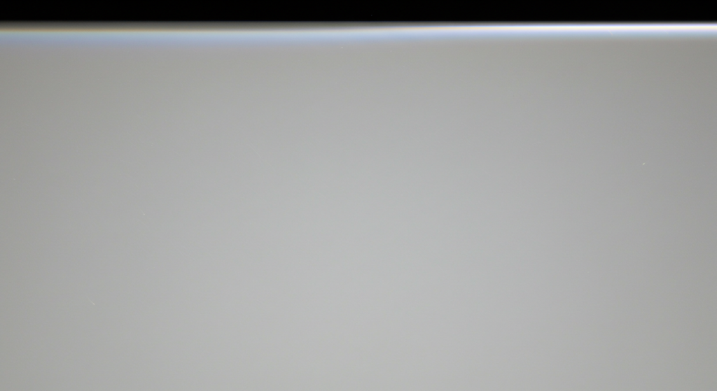 the backlight bleed visible on an LCD monitor screen, showing light leakage around the edges